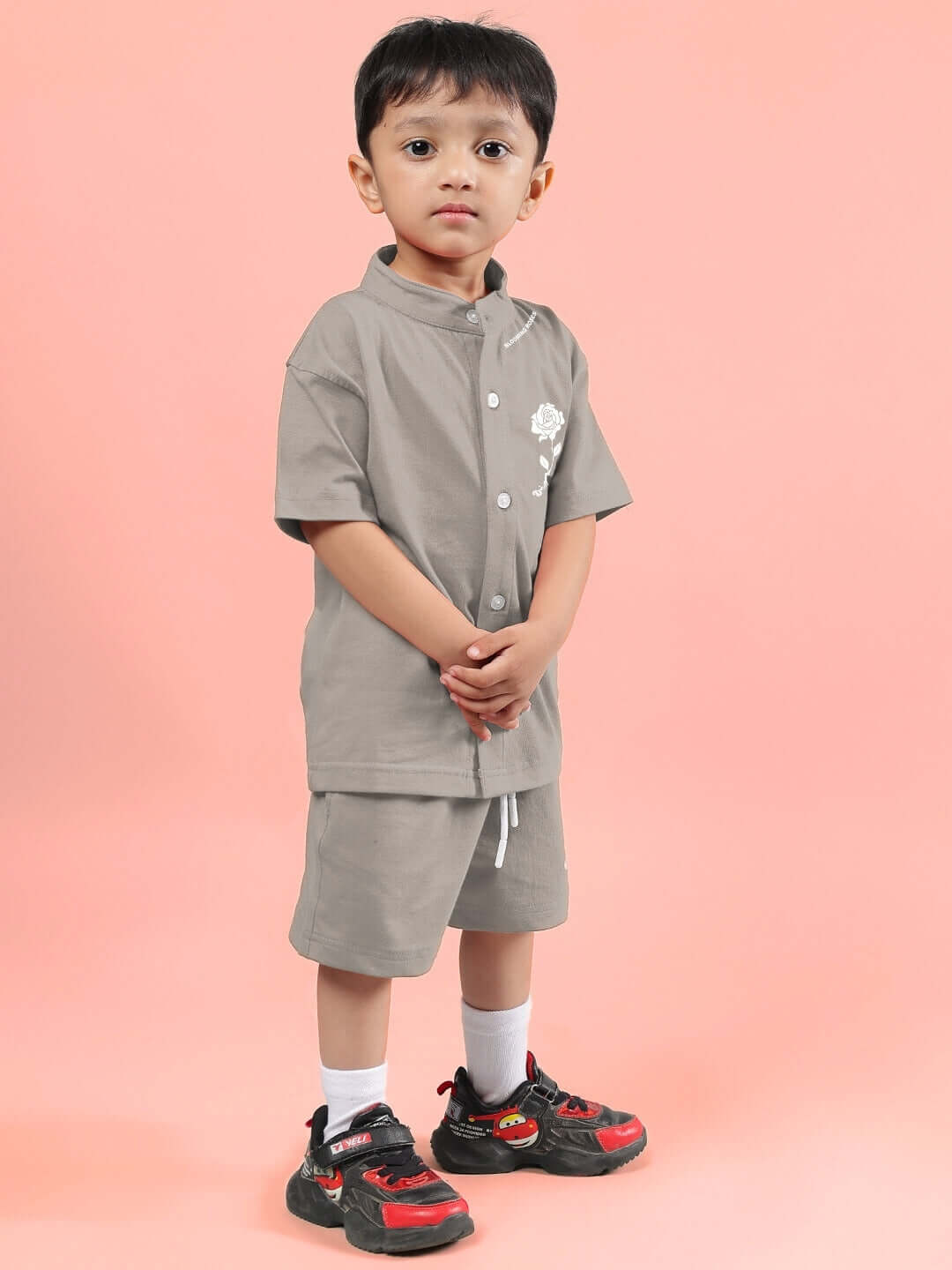 Young child wearing LIMBO CO-ORD FOR BOYS & GIRLS GREY, stylish and comfortable cotton-blend outfit, posed against a peach background.