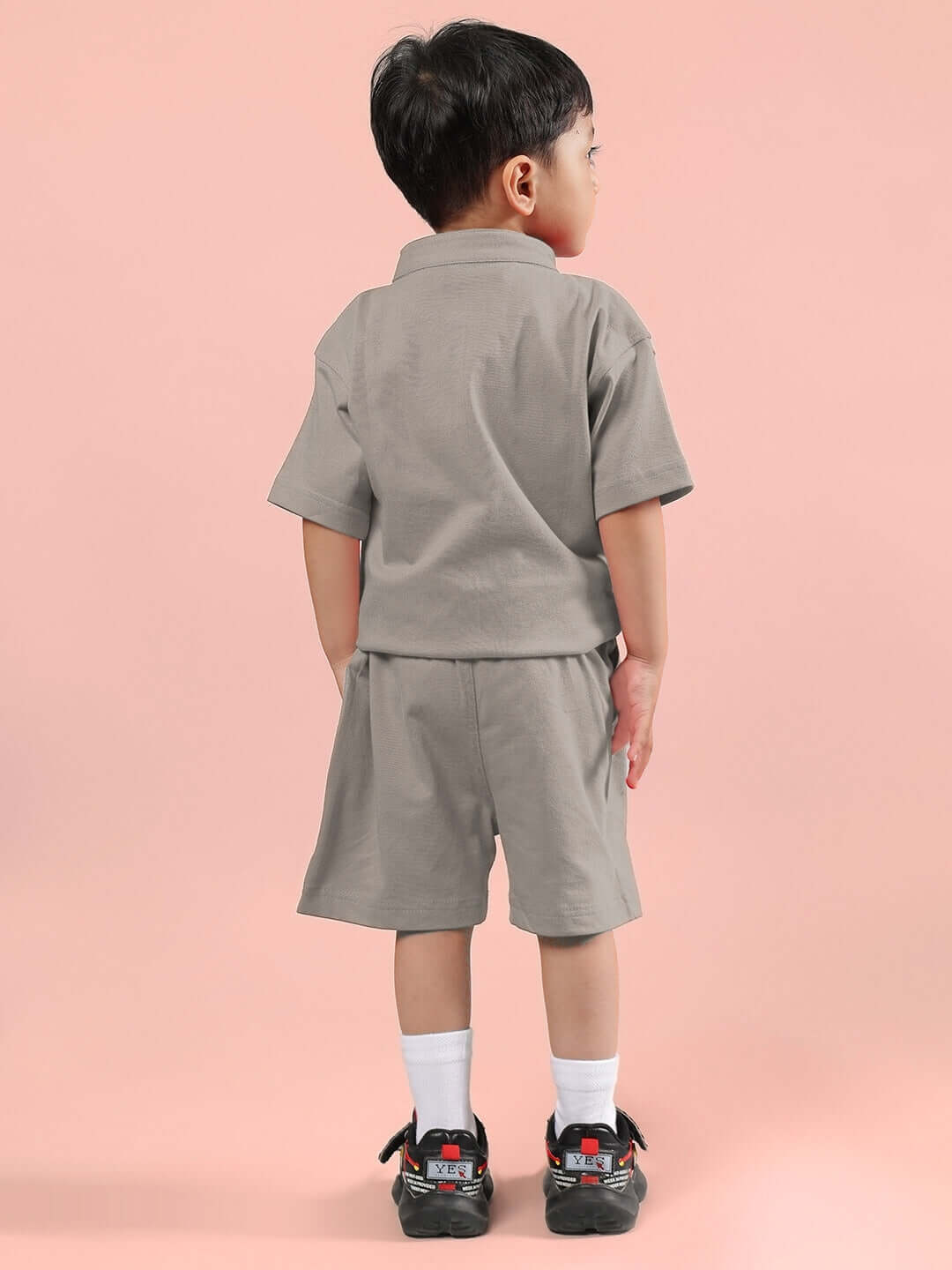 Child wearing LIMBO CO-ORD FOR BOYS & GIRLS GREY set with shirt and shorts, showcasing comfortable and stylish kidswear.