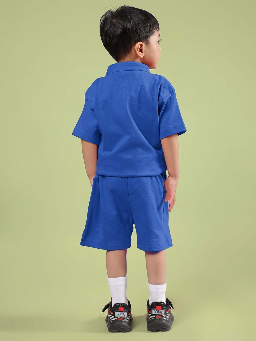 Child wearing LIMBO CO-ORD FOR BOYS & GIRLS BLUE, featuring a comfortable blue shirt and shorts set, ideal for school and play.