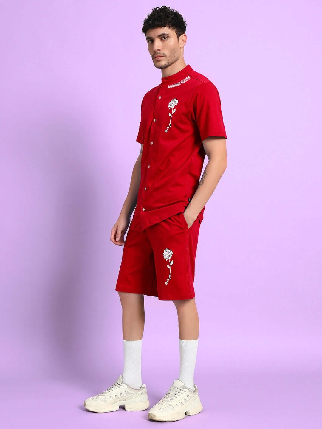 Model wearing LIMBO CO-ORD SET in red, featuring premium cotton French terry fabric, stylish shirt, and shorts, against purple backdrop.
