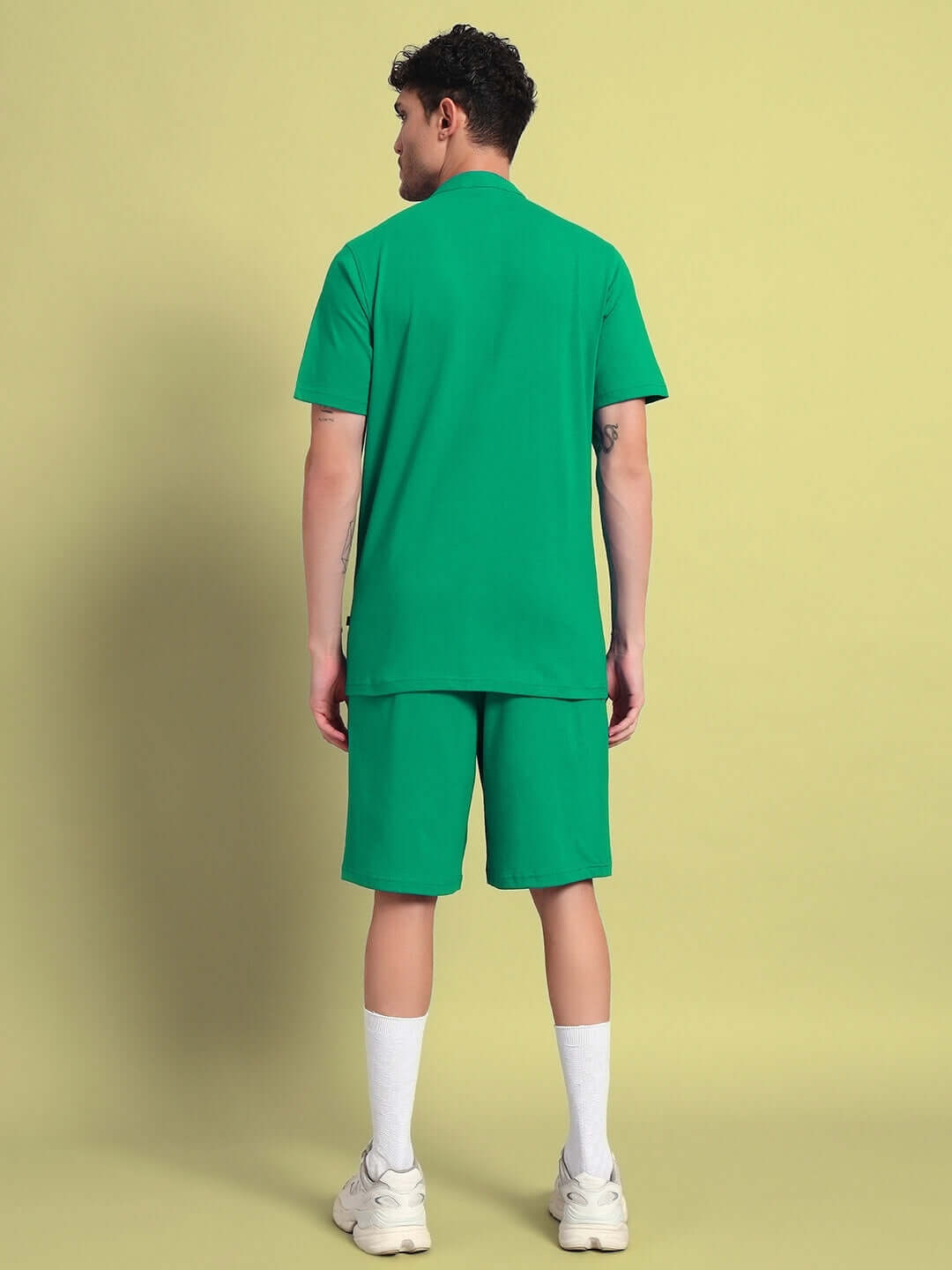 Man wearing green LIMBO CO-ORD set, premium cotton French terry fabric, bio-washed, standing against neutral background, back view.