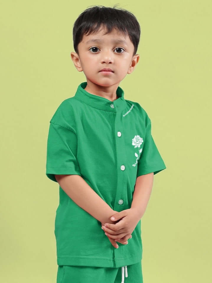 Child wearing a green Limbo shirt for boys and girls by DUDS, showcasing the front design and fit.