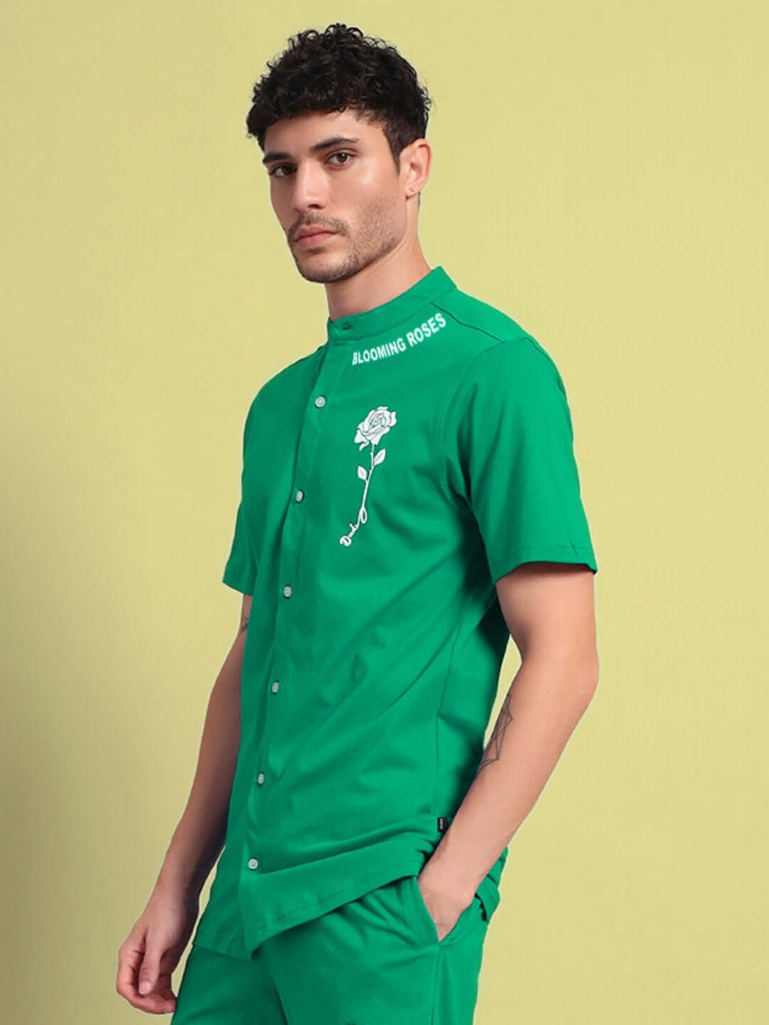 Man wearing green LIMBO regular fit shirt with floral embroidery, made from premium cotton, suitable for casual wear.
