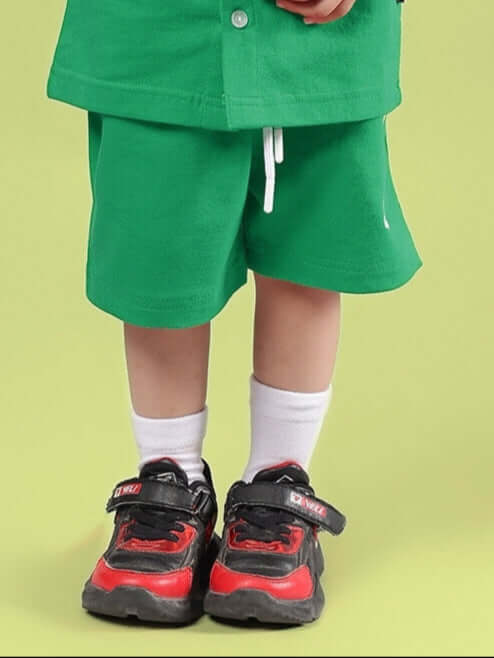 LIMBO SHORTS FOR BOYS & GIRLS GREEN shown worn by a child, highlighting comfort and style for everyday activities.