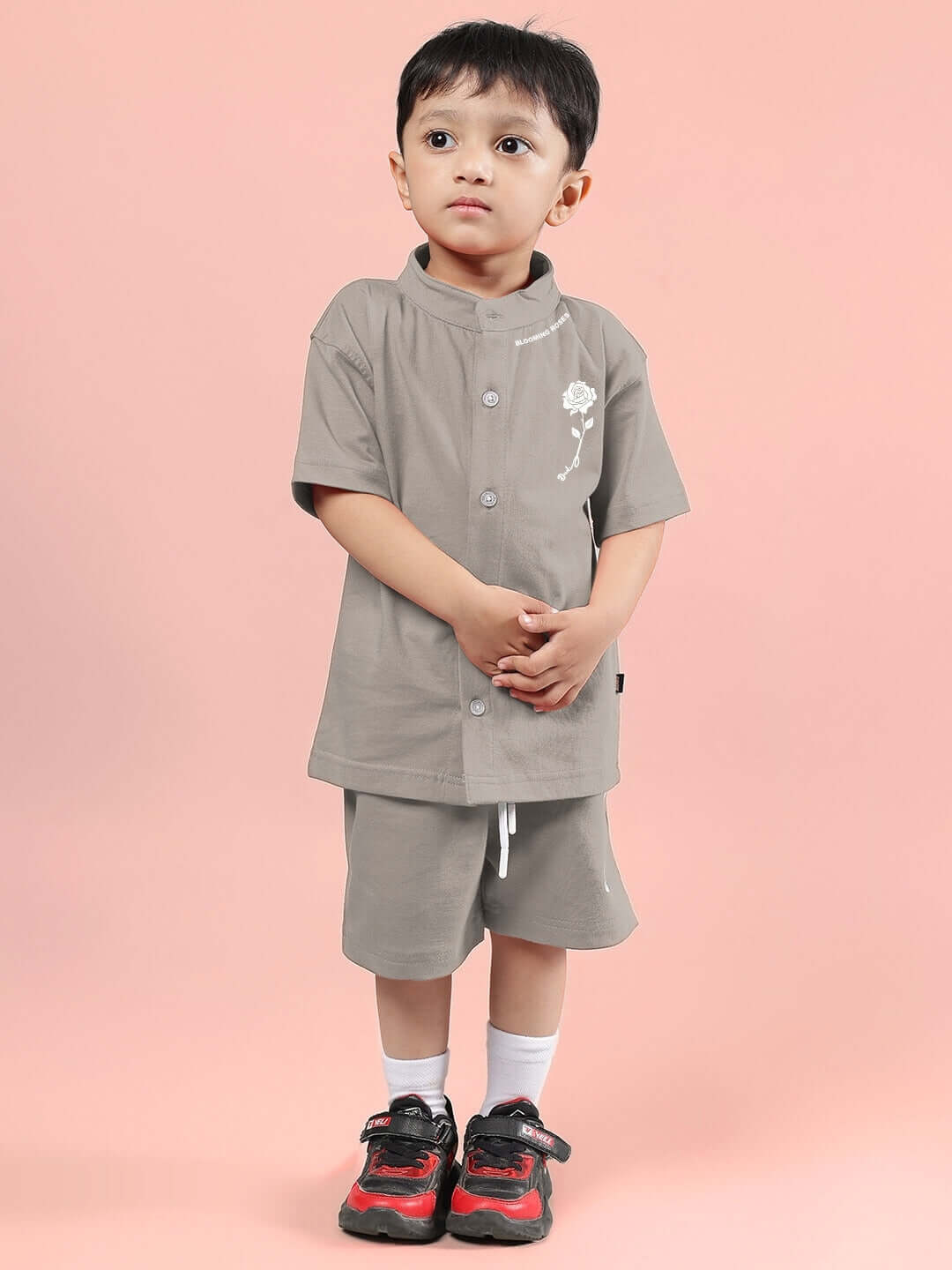 Young child wearing LIMBO CO-ORD FOR BOYS & GIRLS GREY ensemble against a pink background, showcasing modern and comfortable kids' fashion.