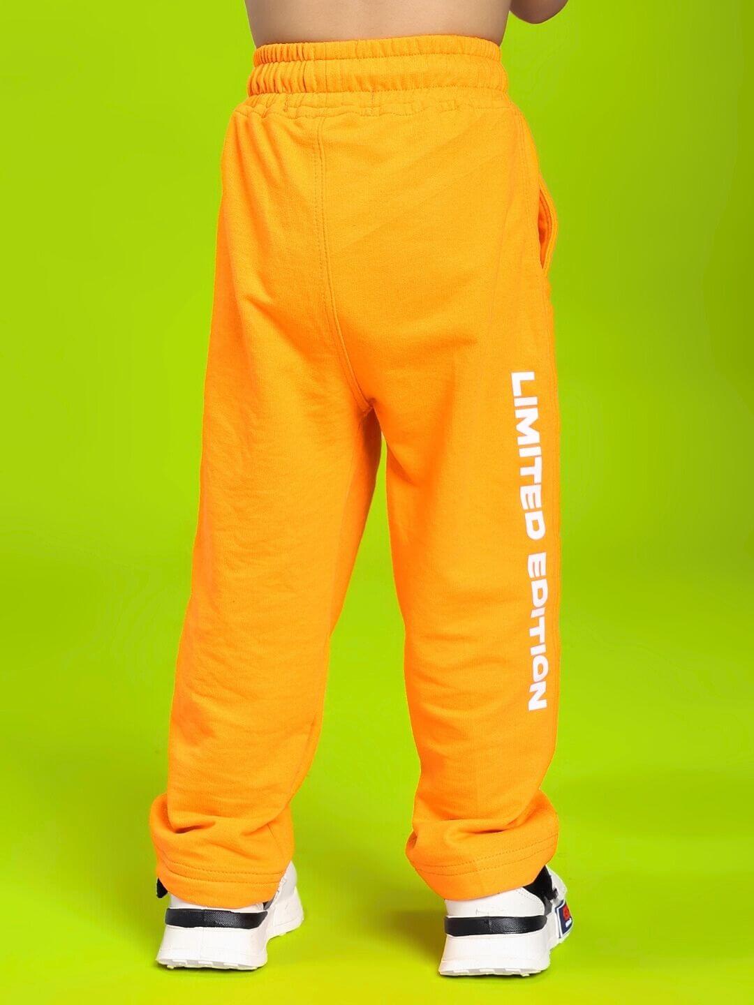 Child wearing LIMITED EDITION JOGGER FOR BOYS AND GIRLS ORANGE, showing vibrant orange color and relaxed fit for active play.