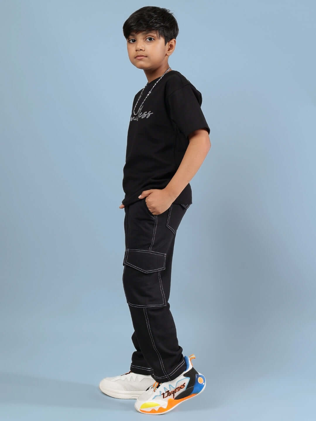 Child wearing LIMITLESS CO-ORD FOR BOYS GIRLS BLACK showcasing sleek black outfit for all-day comfort and motivation.