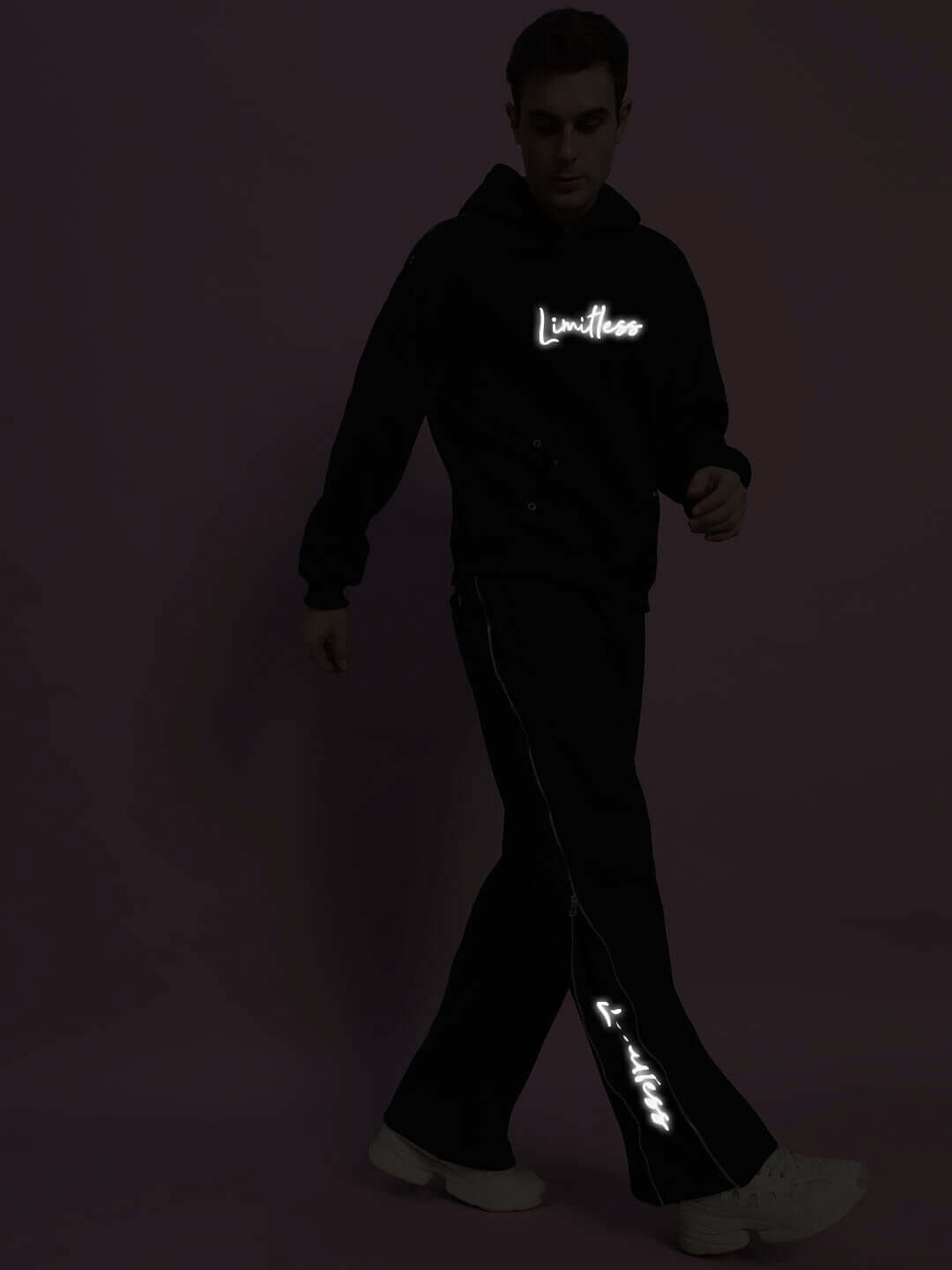 LIMITLESS FLEECE REFLECTOR CO-ORD BLACK set in a stylish pose highlighting the reflective accents.