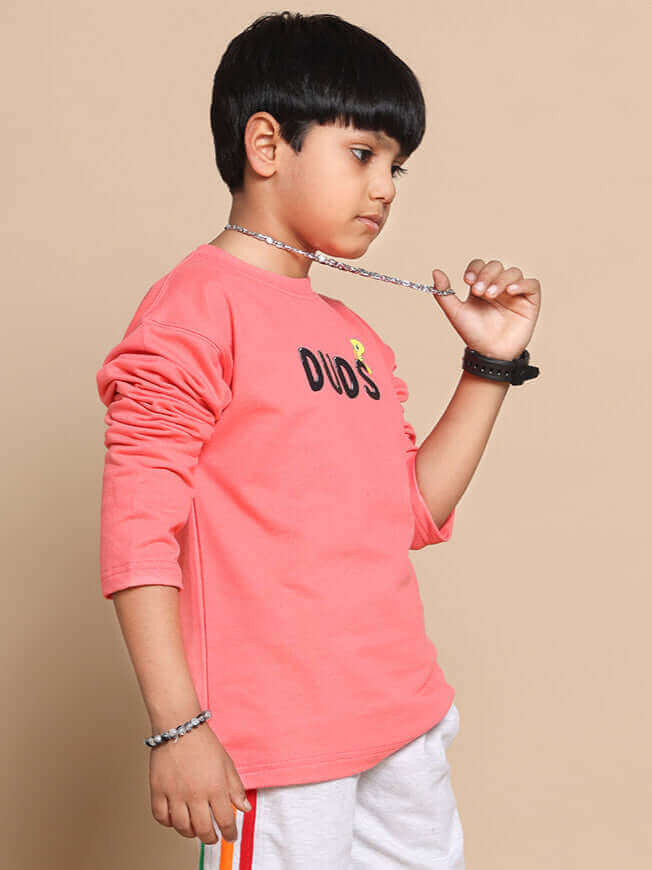 Child wearing peach DUDS co-ord set with long sleeves, showcasing trendy style for boys and girls. Made to order fashion piece.