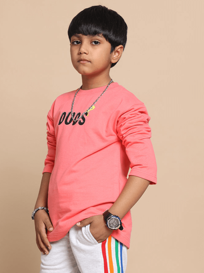 Boy wearing peach oversized sweatshirt for kids with 'DUDS' logo, long sleeves, and casual style, perfect for custom fit options.
