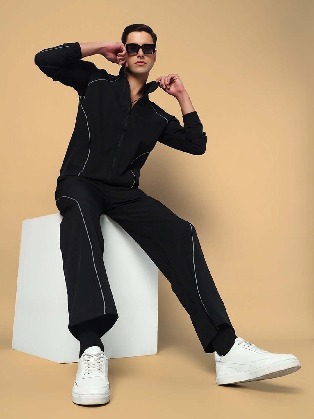 Model wearing LOCO OVERSIZED CO-ORD SET BLACK with sleek black jacket and pants, showcasing bold streetwear fashion.