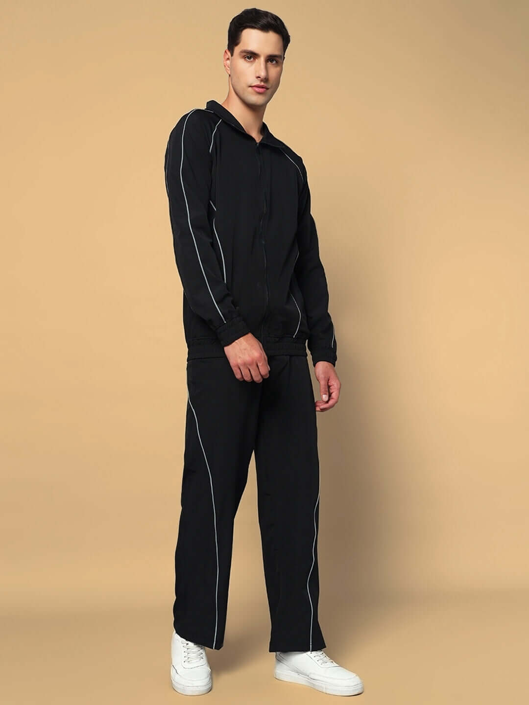 Model wearing LOCO REFLECTOR PARACHUTE CARGO PANTS in black, featuring reflective details for a stylish look, available in custom fit.