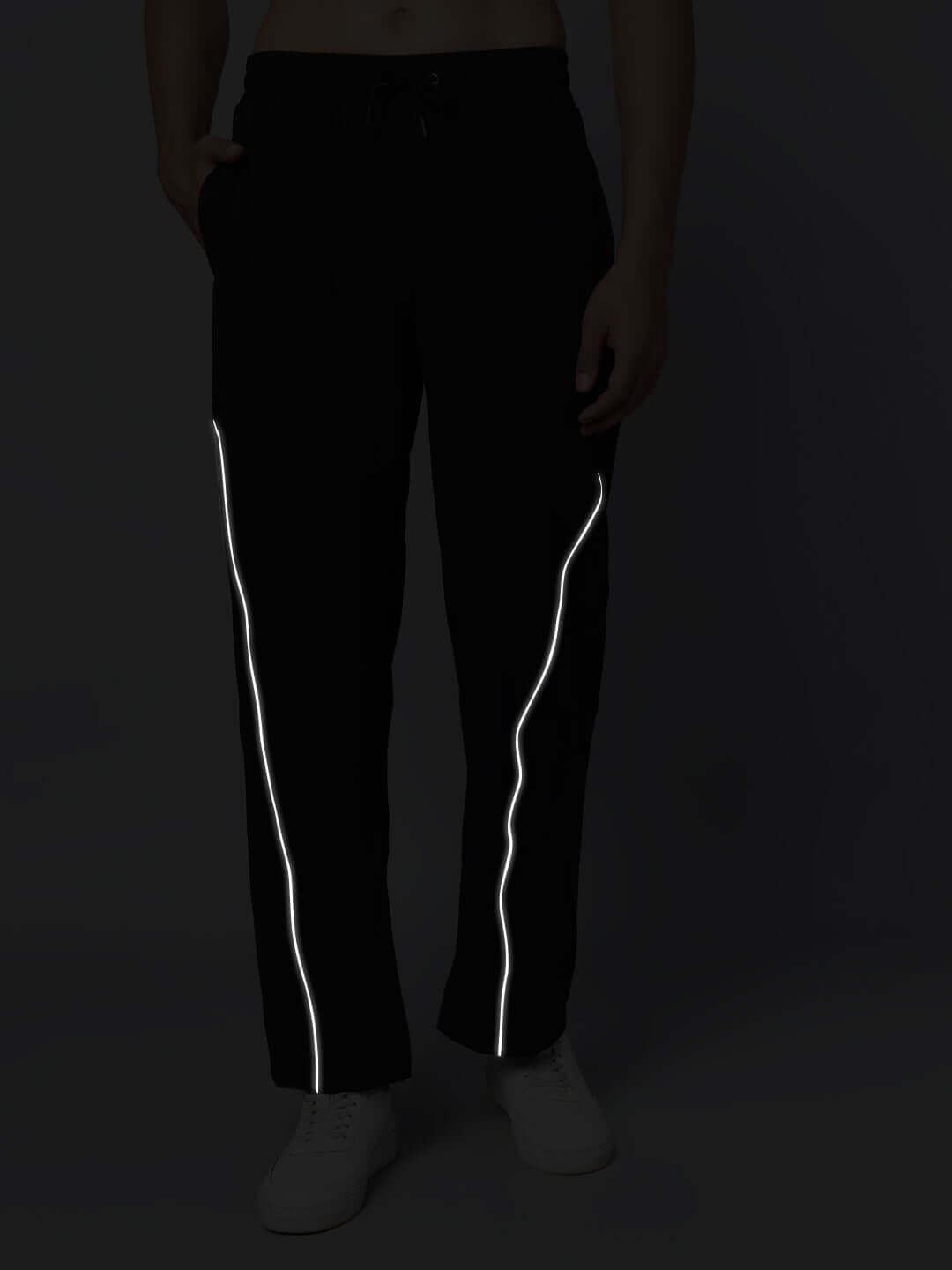 Black oversized unisex joggers with elasticated waistband, highlighted with reflective stripes for a modern look.