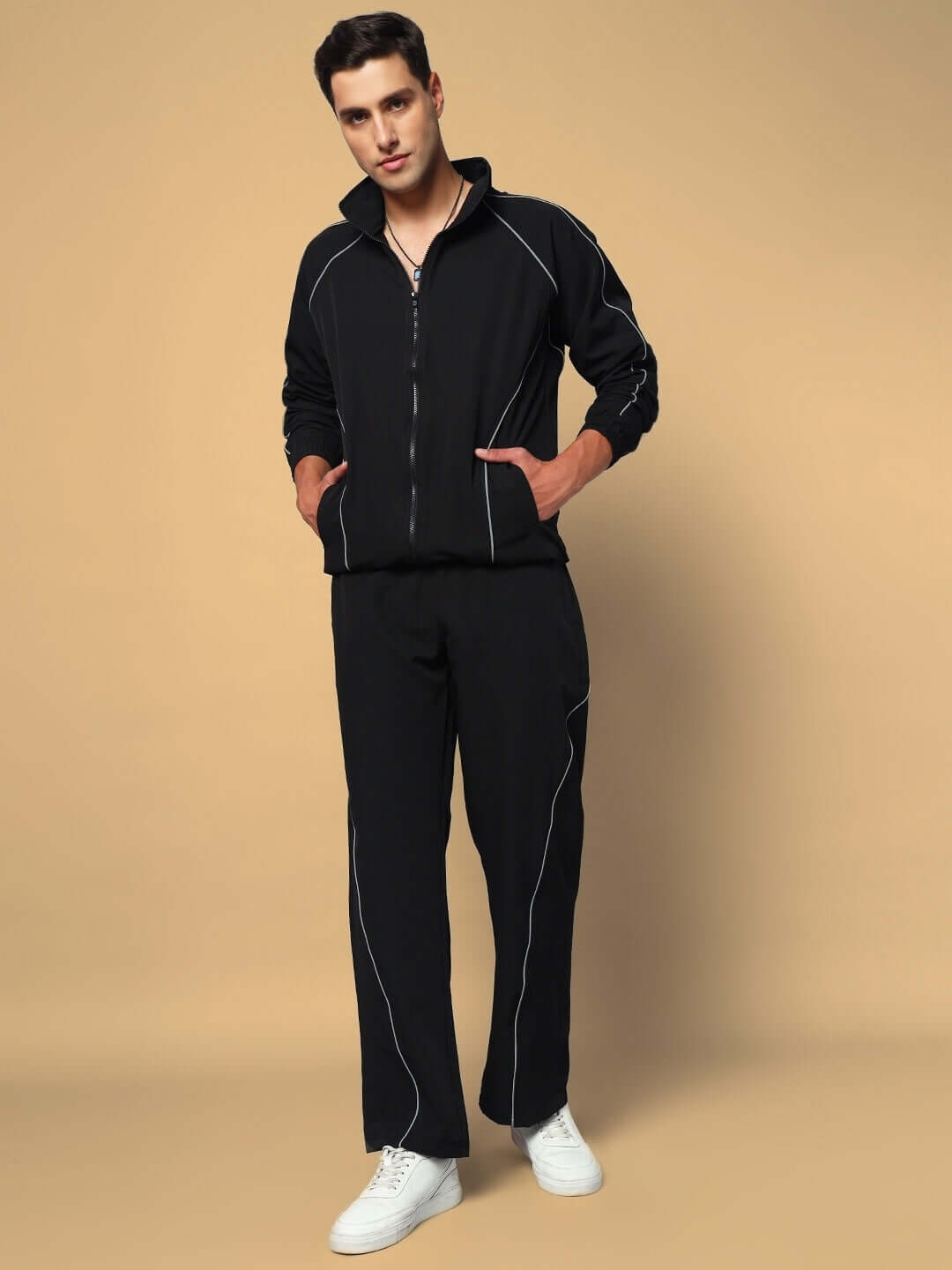 Model wearing LOCO OVERSIZED CO-ORD SET BLACK, sleek black streetwear outfit with zip-up jacket and pants, styled with white sneakers.