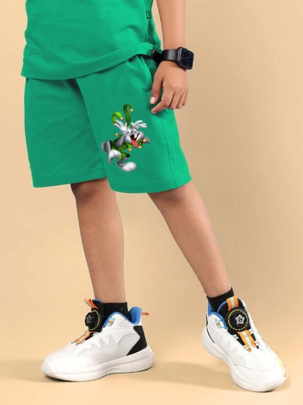 Child wearing LOONEY TUNES PRINTED SHORTS FOR BOYS & GIRLS GREEN with character graphic.