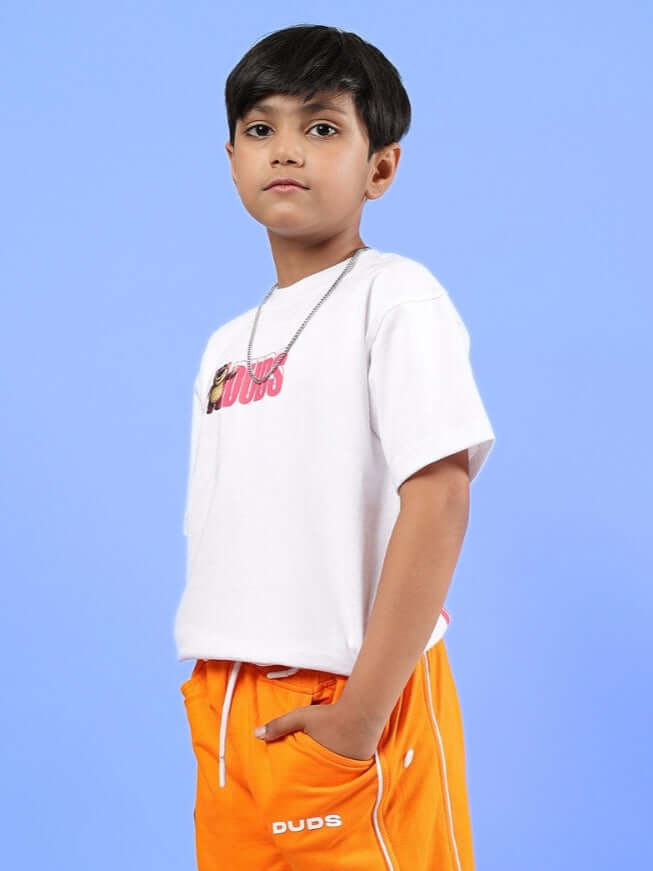 Child wearing LOTSO OVERSIZED T-SHIRT FOR BOYS GIRLS WHITE against blue background.