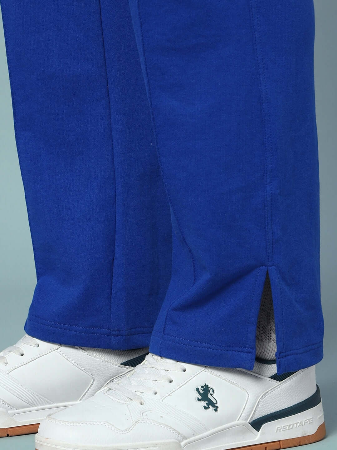 Bottom view of LOVE DREAMS OVERSIZED CO-ORD SET joggers paired with white sneakers.