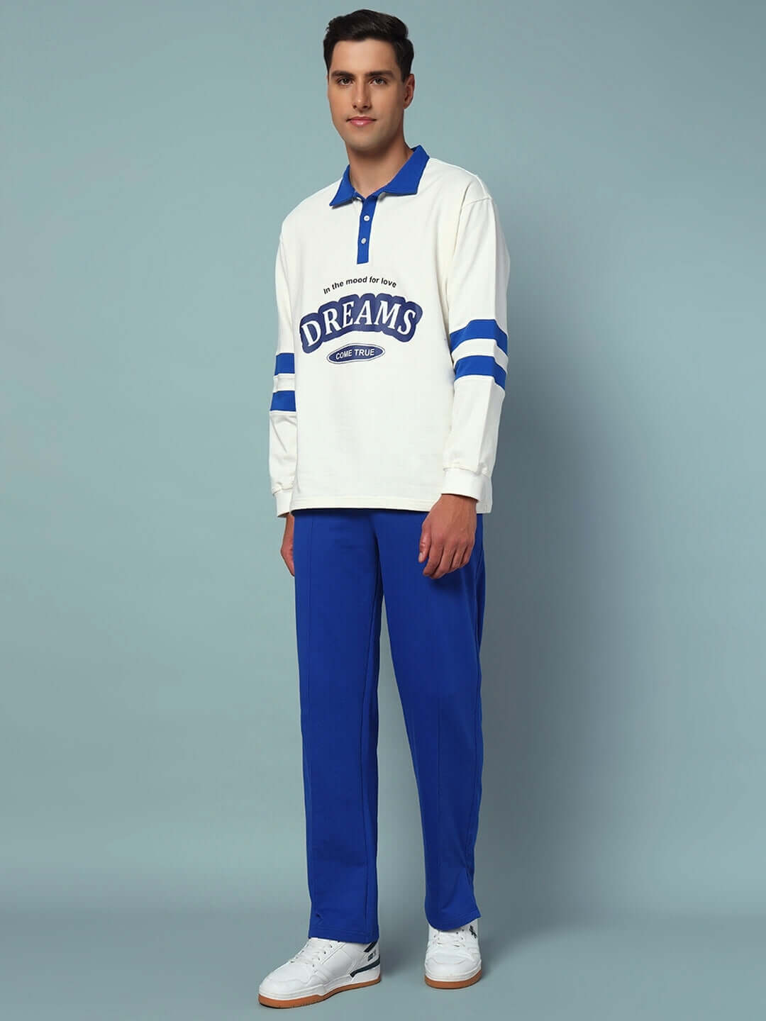 Model wearing LOVE DREAMS OVERSIZED CO-ORD SET with white sweatshirt and blue joggers.