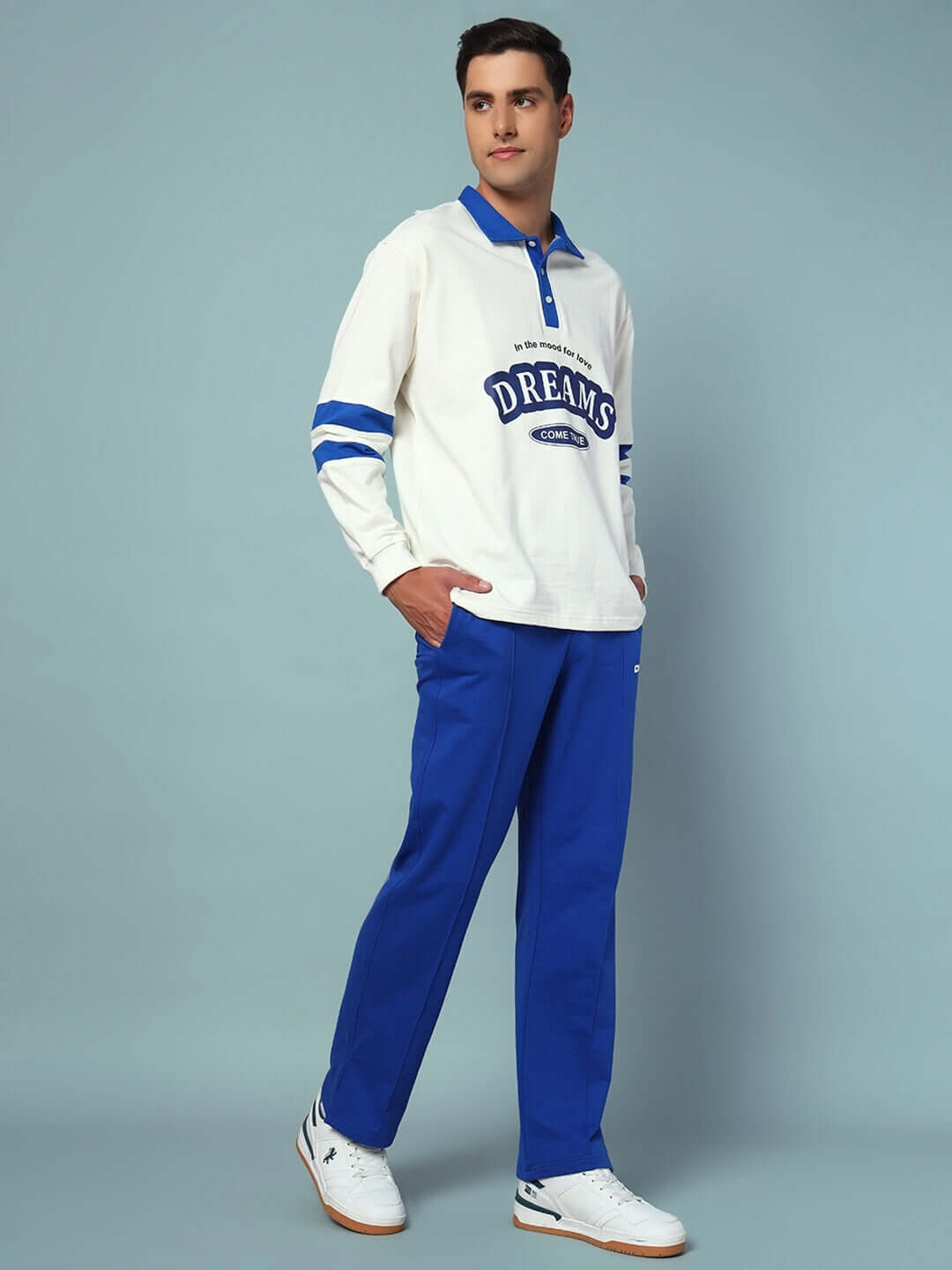 Model wearing LOVE DREAMS OVERSIZED CO-ORD SET with blue joggers and white sweatshirt.