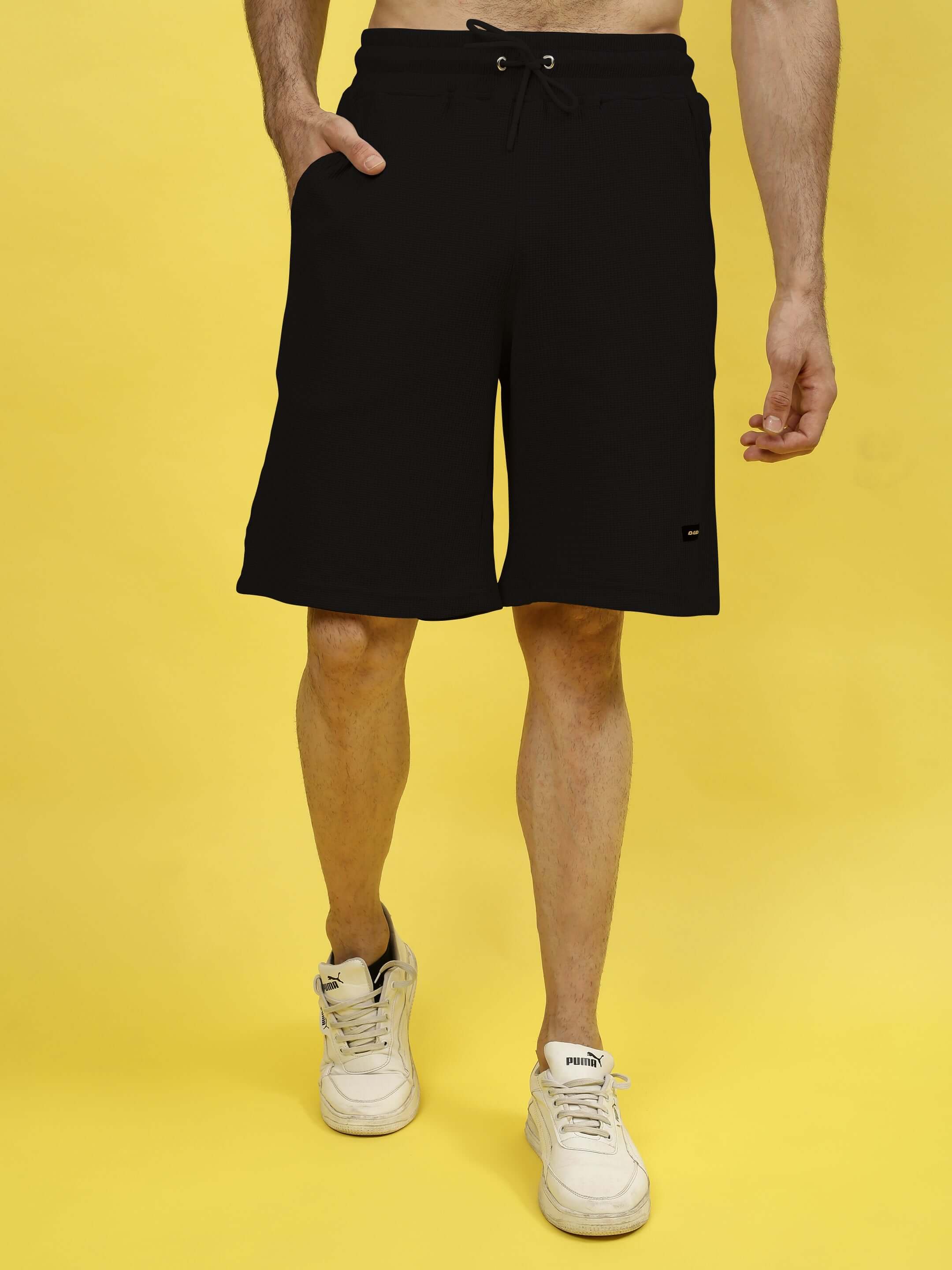Model wearing LOW-KEY SOLID CO-ORD SET in black, made from premium waffle cotton fabric, showcasing comfort and style against a yellow background.
