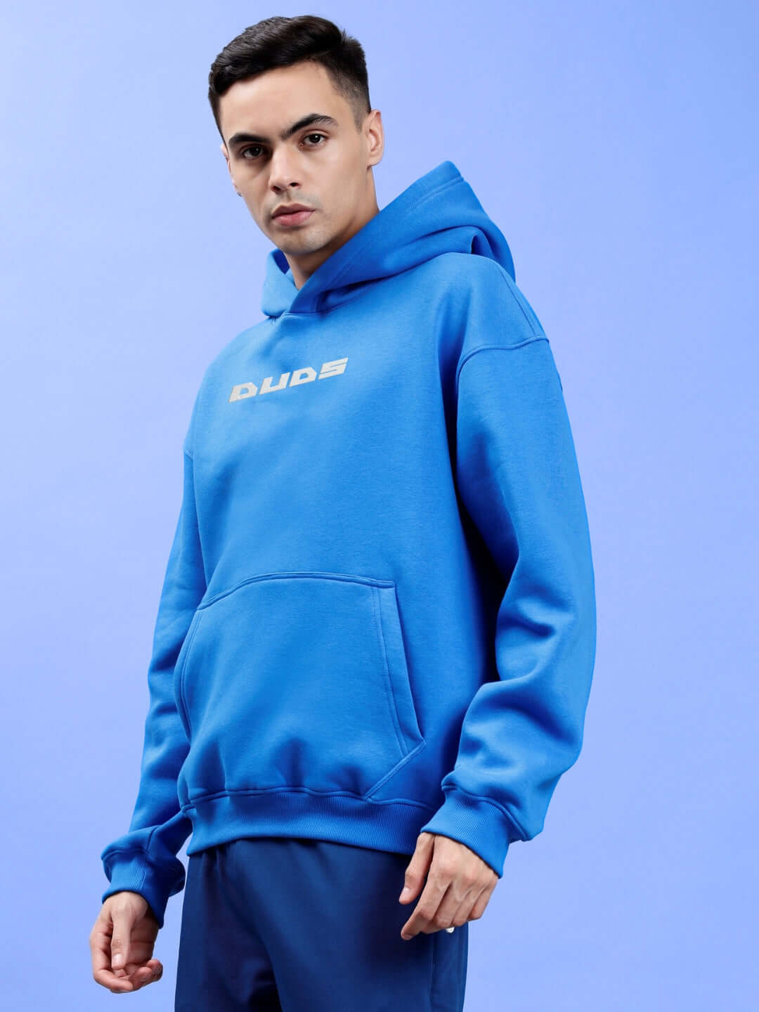 Alt Tag: LUNA FLECCE OVERSIZED HOODIE ROYAL BLUE, cozy streetwear in premium fleece, trendy relaxed fit, model wearing on blue background