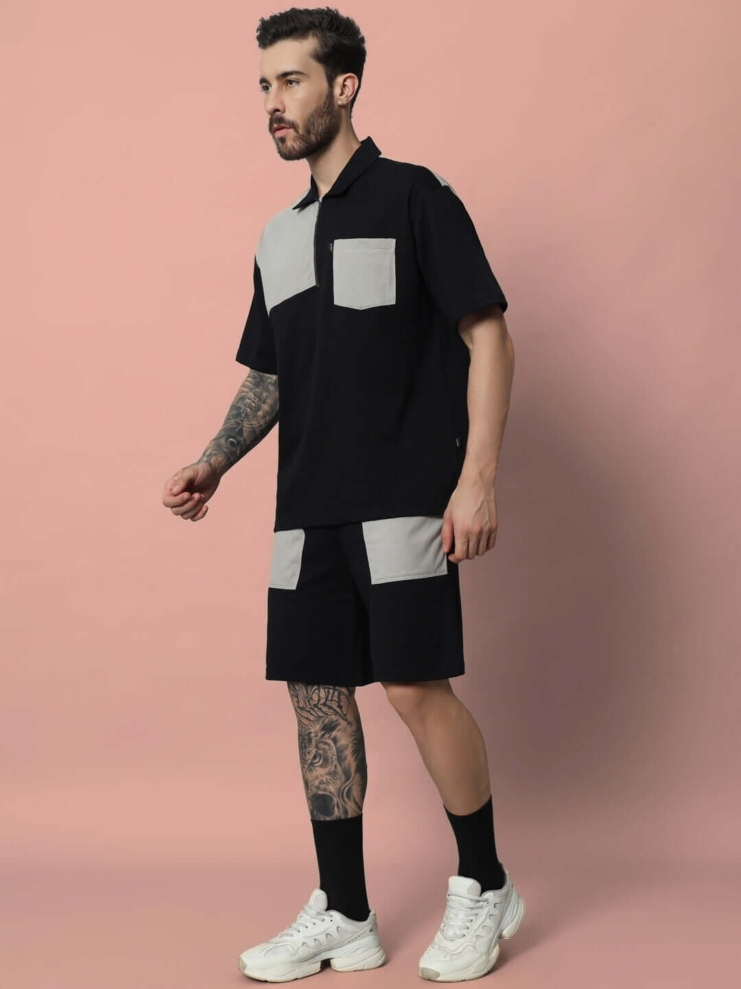 Model wearing Lustre Co-ord Set in Black Grey, premium cotton blend, short sleeves and shorts, stylish casual outfit, side profile view.