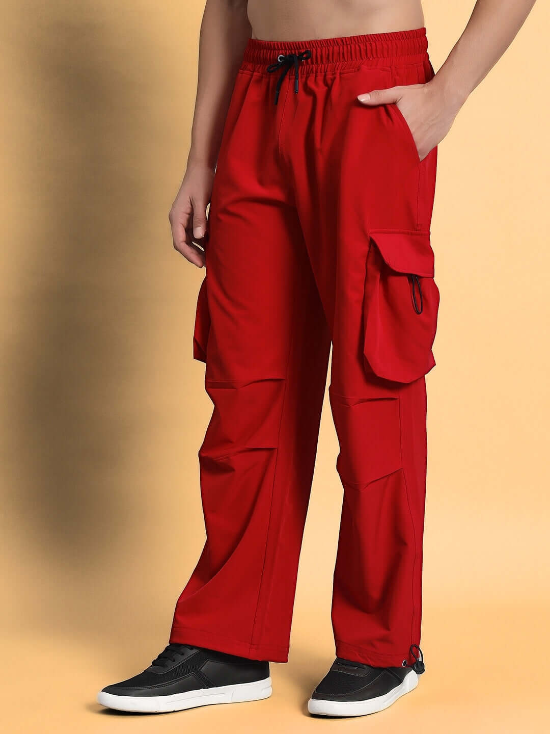 Model wearing Mabel relaxed fit cargo pants in red, featuring side pockets, adjustable waistband, and casual style; custom fit available.