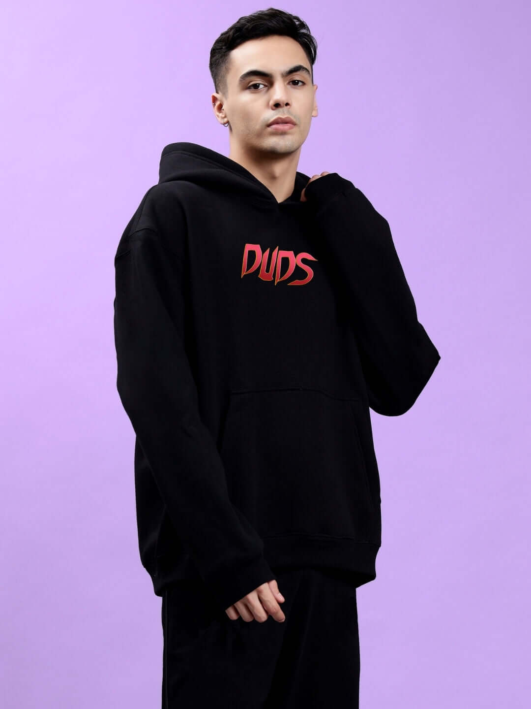 Model wearing Mafia Fleece Oversize Hoodie Black with bold graphic on front, showcasing trendy and edgy streetwear style.
