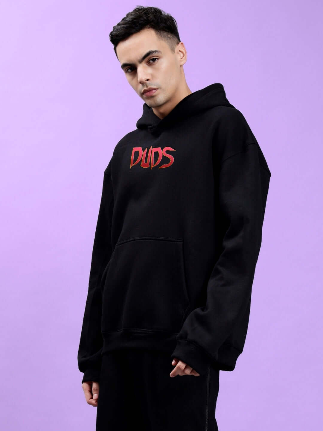 MAFIA FLEECE OVERSIZE HOODIE BLACK with bold graphic displayed on a model, showcasing the edgy and comfortable design in a studio setting.