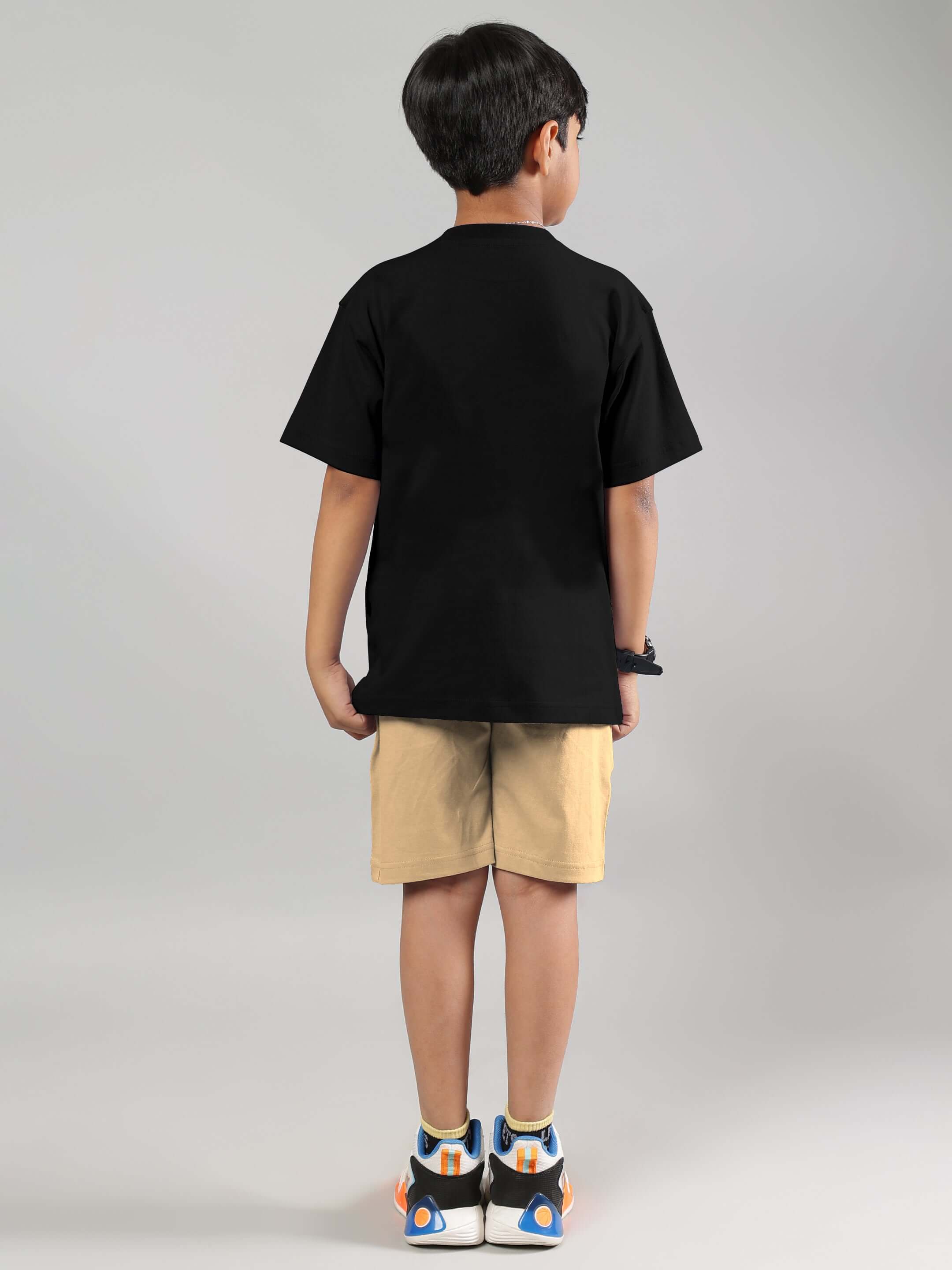 Child wearing a black and beige Magic City co-ord set, showcasing the back view. Ideal for boys and girls, emphasizing comfort and style.