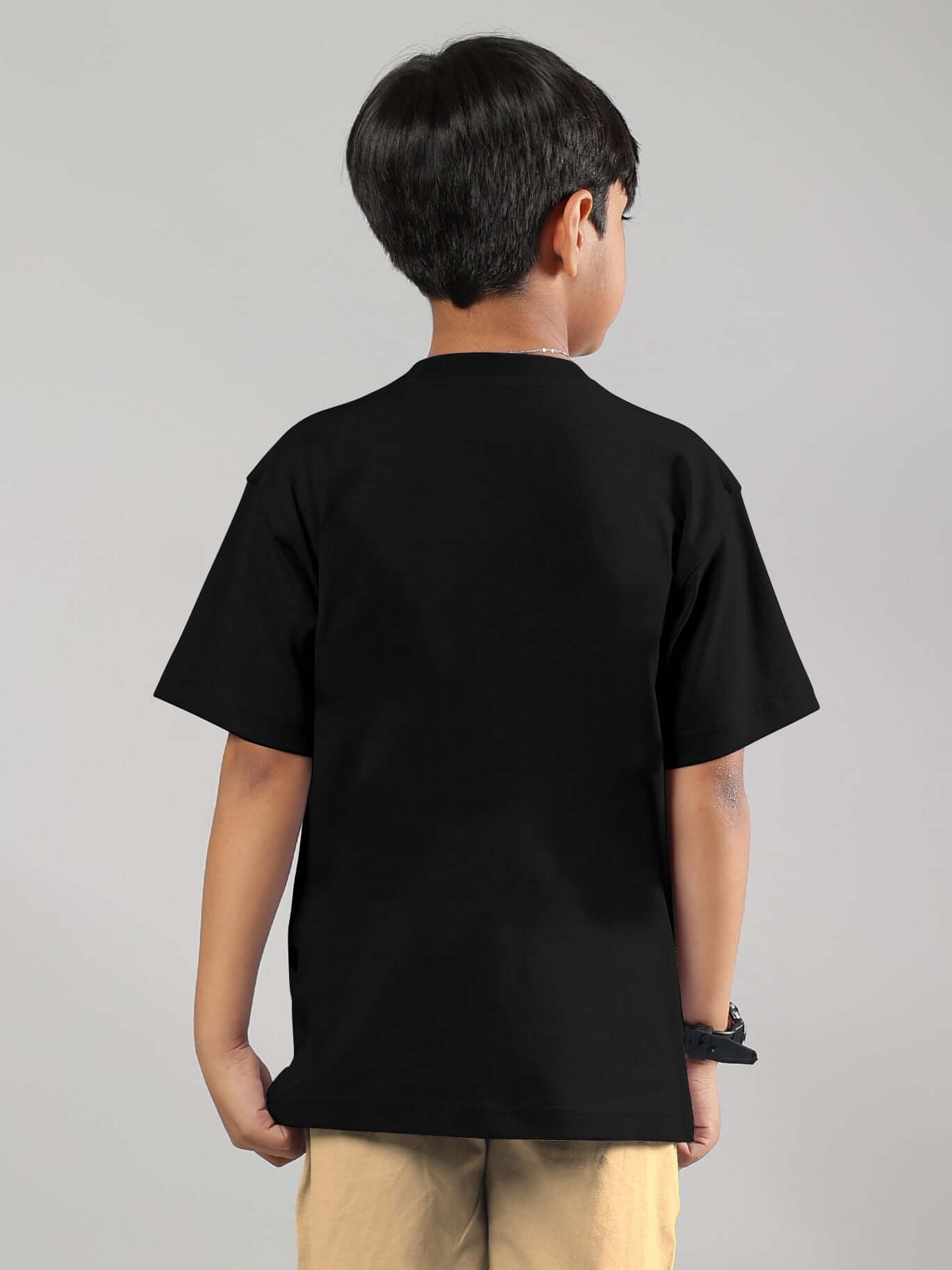 Child wearing Magic City T-Shirt for Boys Girls Black, showcasing the back design of the streetwear tee for trendy urban-inspired fashion.