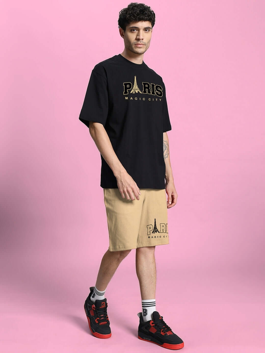 Model wearing MAGIC CITY SUMMER CO-ORD SET BLACK BEIGE with a black t-shirt and beige shorts, showcasing an effortless summer style.