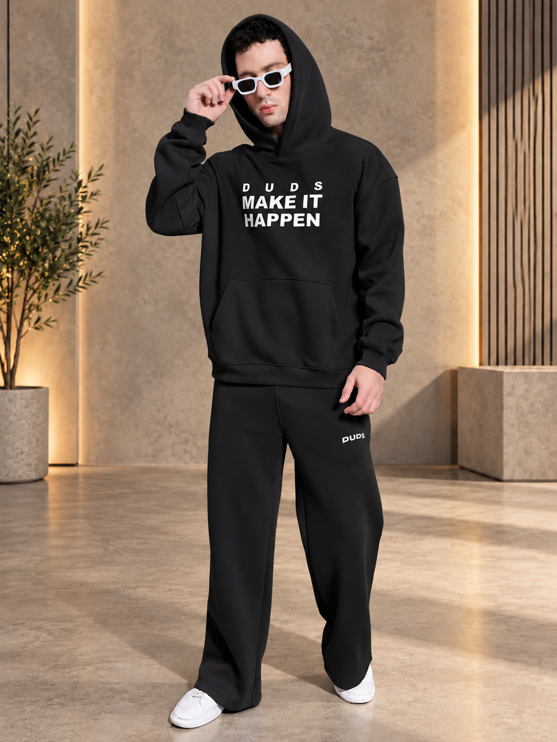 MAKE IT HAPPEN COTTON FLEECE JOGGER BLACK styled with matching hoodie, white sneakers, and sunglasses for a trendy streetwear look