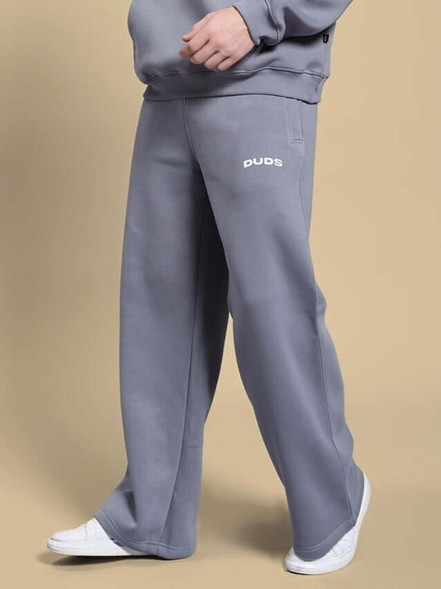 MAKE IT HAPPEN COTTON FLEECE JOGGER GREY on model with white sneakers, showcasing comfortable and durable street-style fashion.