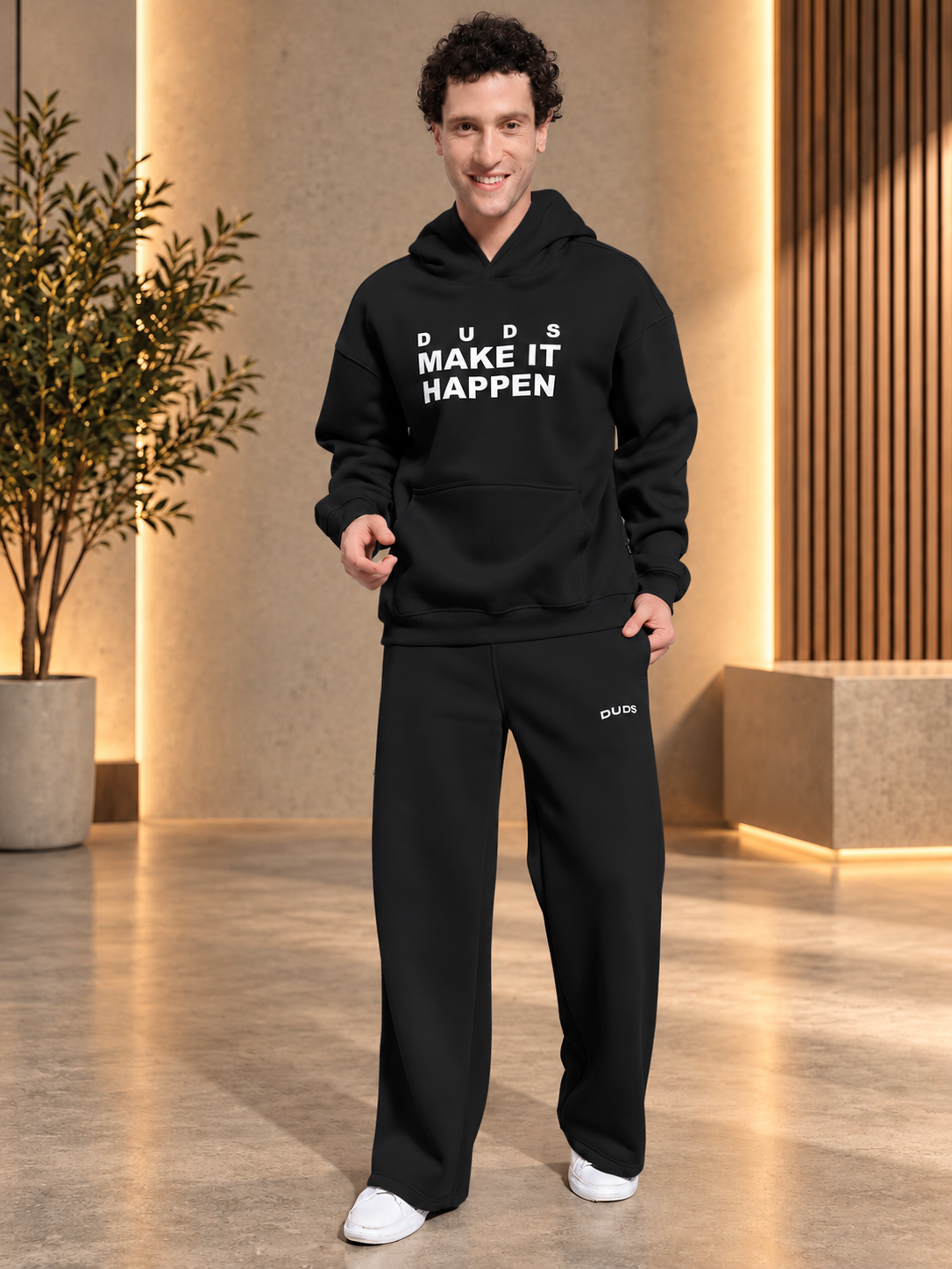 MAKE IT HAPPEN FLEECE CO-ORD SET BLACK worn by man in stylish hoodie and sweatpants for casual comfort