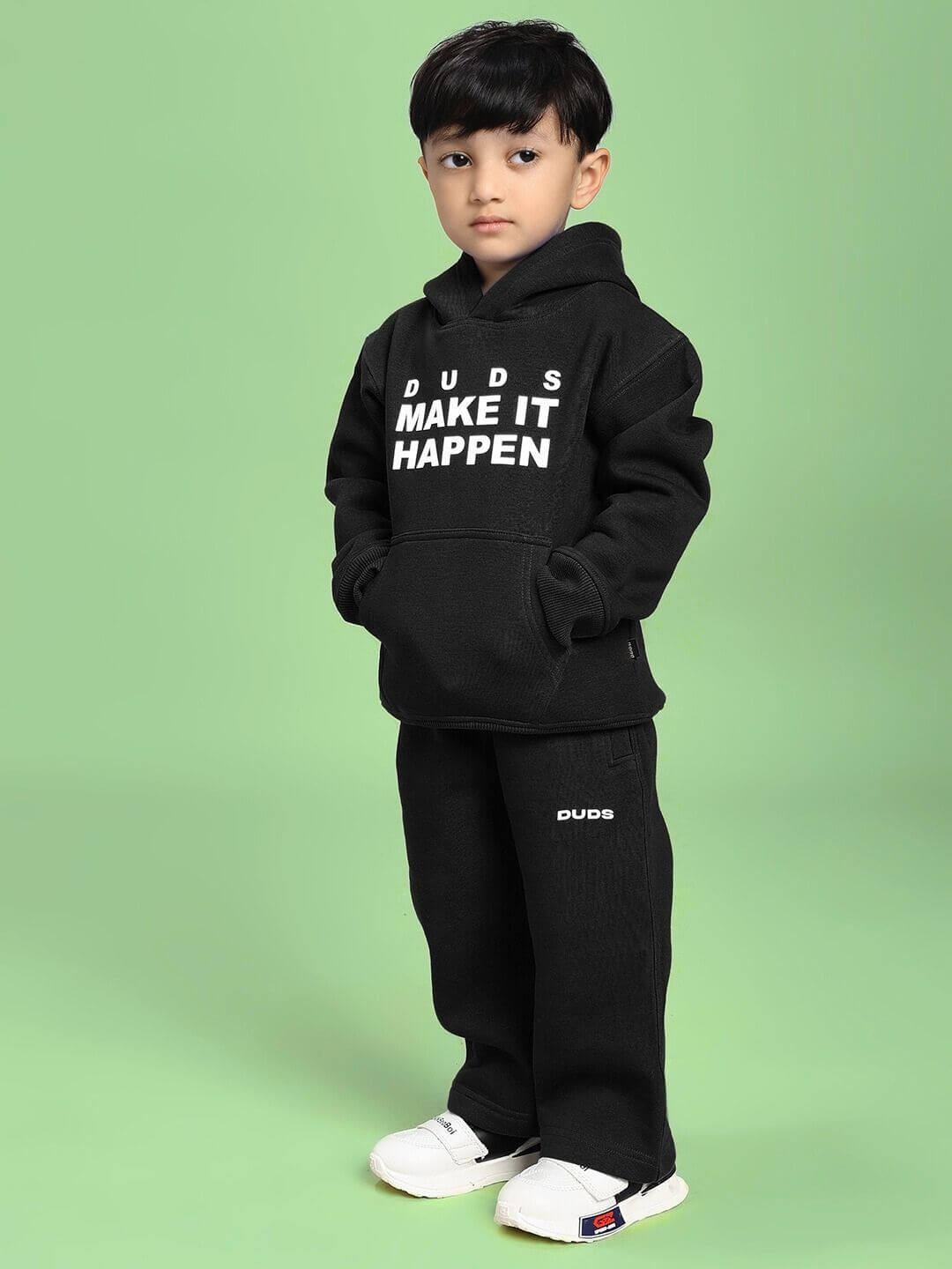 Child wearing MAKE IT HAPPEN FLEECE CO-ORD FOR BOYS AND GIRLS BLACK, stylish and comfortable outfit perfect for kids' daily adventures.