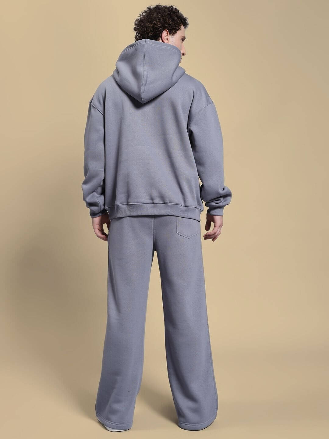 Back view of model wearing MAKE IT HAPPEN FLEECE CO-ORD SET GREY, a casual hoodie and joggers ensemble for stylish comfort and relaxation.