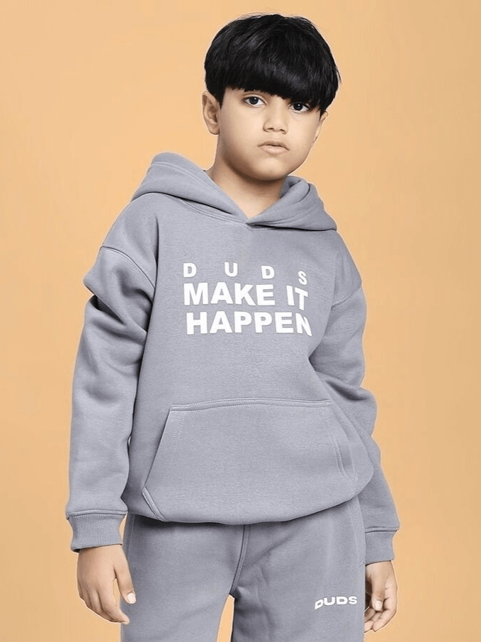 Young boy in MAKE IT HAPPEN FLEECE HOODIE FOR BOYS AND GIRLS GREY with drawstring hood, showcasing comfort and style.