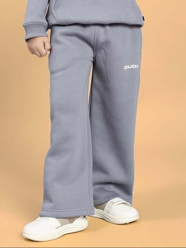 Child wearing MAKE IT HAPPEN FLEECE JOGGER FOR BOYS AND GIRLS GREY, showcasing comfortable and stylish design for kids' everyday wear.