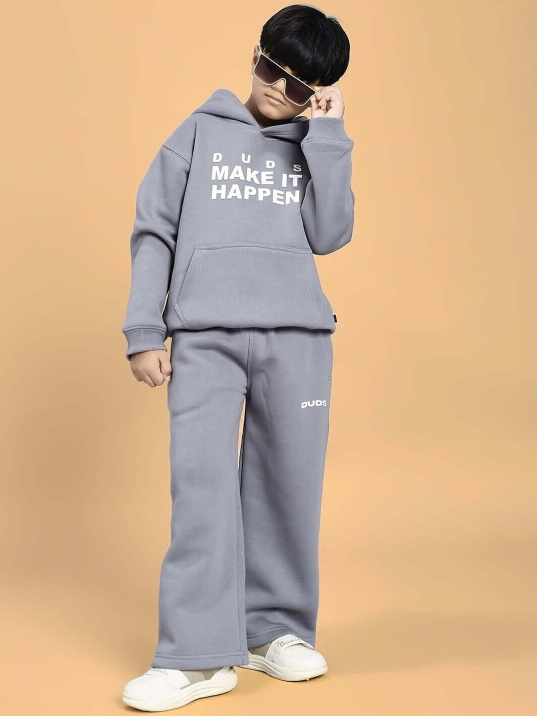 Child wearing MAKE IT HAPPEN FLEECE JOGGER FOR BOYS AND GIRLS GREY, stylish and comfortable outfit for kids, featuring soft brushed fleece.