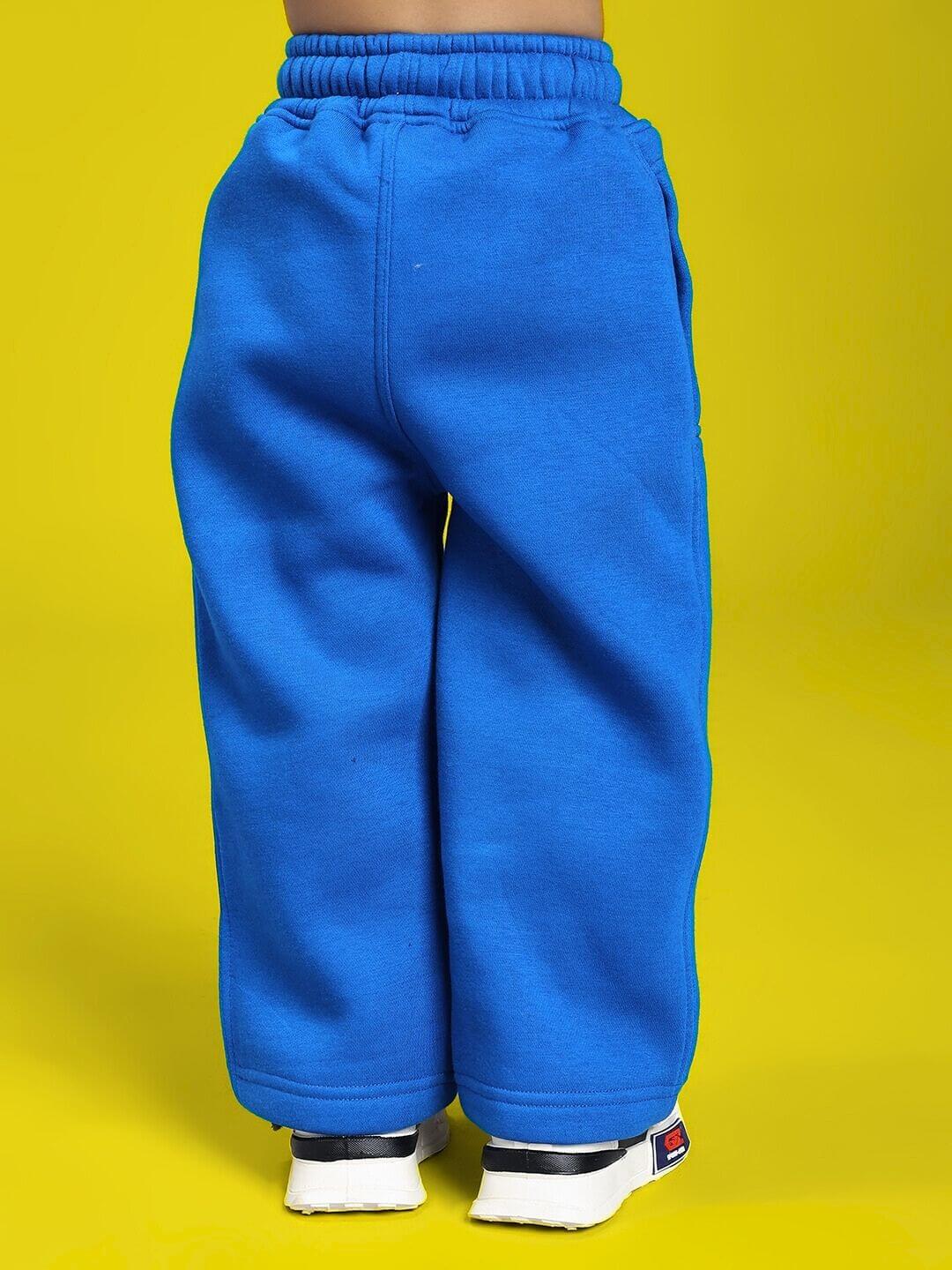 Child wearing MAKE IT HAPPEN FLEECE JOGGER FOR BOYS AND GIRLS ROYAL BLUE on a vibrant background, showcasing comfort and style.