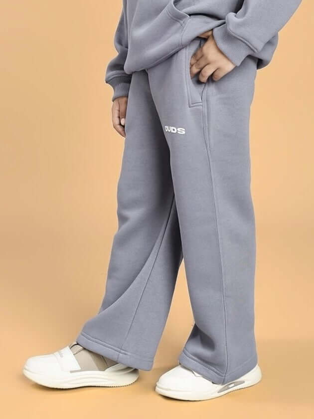 Child wearing MAKE IT HAPPEN FLEECE JOGGER FOR BOYS AND GIRLS GREY, featuring soft grey fabric and relaxed fit.