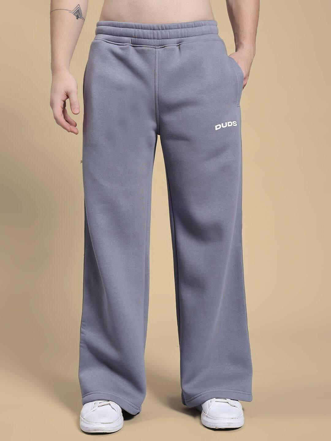 Person wearing MAKE IT HAPPEN COTTON FLEECE JOGGER GREY with wide legs and pockets, showcasing comfort and style.