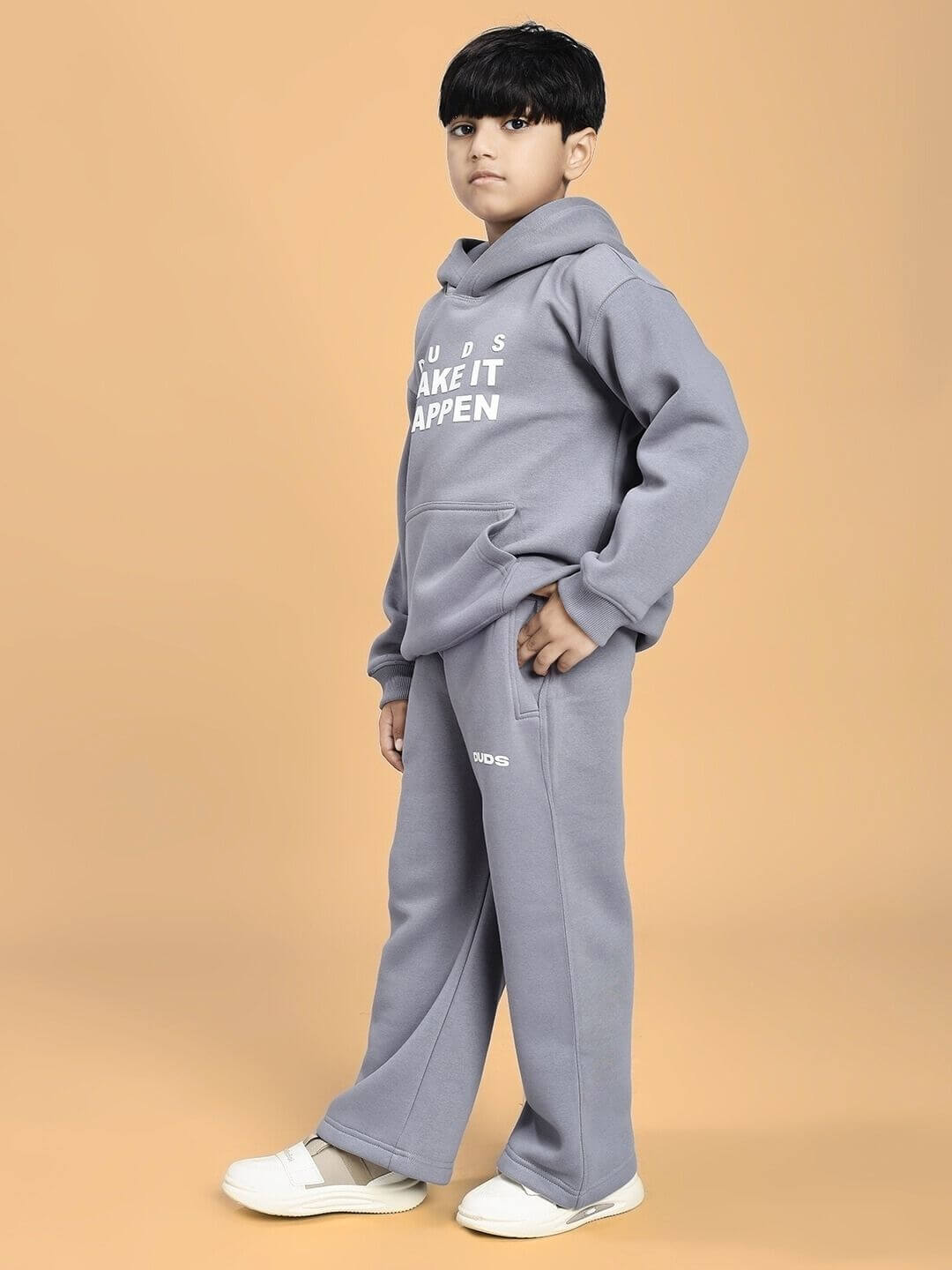 Child wearing MAKE IT HAPPEN FLEECE CO-ORD FOR BOYS AND GIRLS GREY, a cozy two-piece fleece outfit, standing confidently in a studio setting.