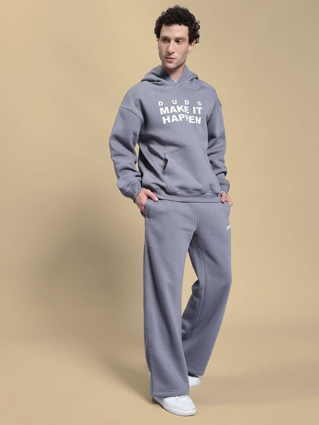 Model wearing MAKE IT HAPPEN FLEECE CO-ORD SET GREY, featuring a cozy sweatshirt and joggers, showcasing relaxed and stylish casual wear.