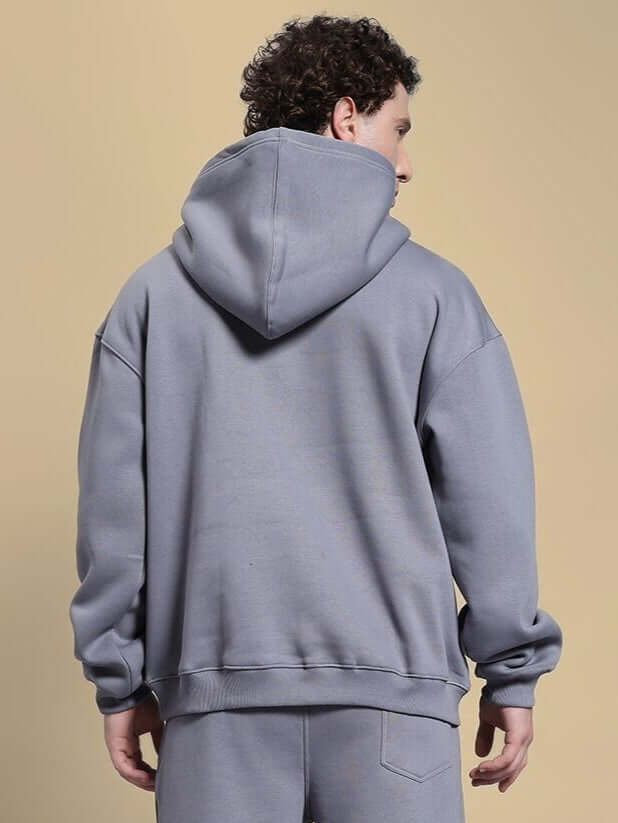 Back view of model wearing a Make It Happen Fleece Hoodie Grey, highlighting its relaxed fit and premium heavyweight material.