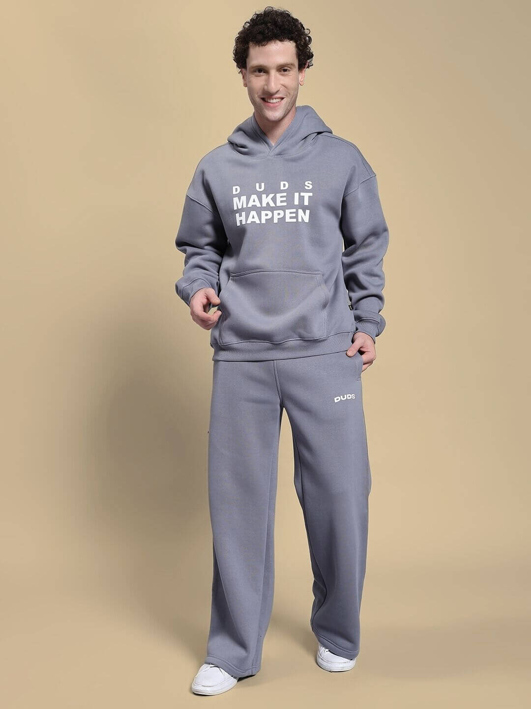 Man wearing the Make It Happen Fleece Hoodie Grey, showcasing relaxed fit and kangaroo pocket.