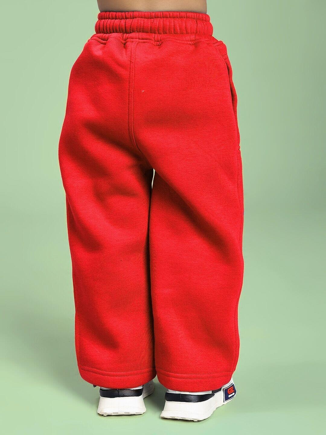 Child wearing MAKE IT HAPPEN FLEECE CO-ORD FOR BOYS AND GIRLS RED showing rear view of pants, perfect for stylish playdates and adventures.