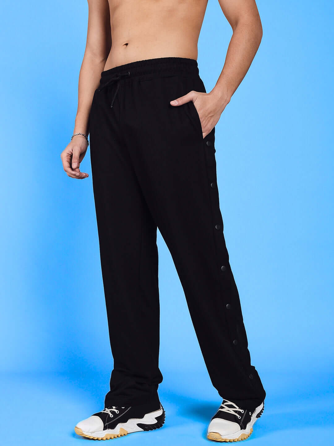 MAMBO Joggers in Red Black with custom fit option, handcrafted by DUDS tailors, shown with a model against a blue background.