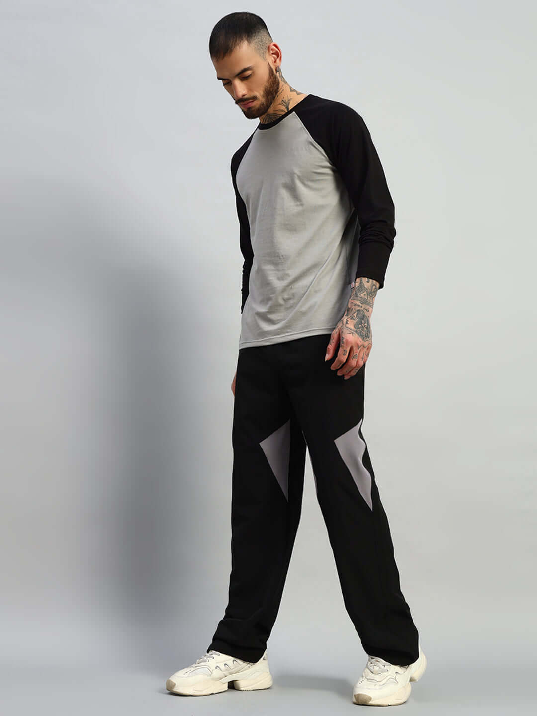 Man wearing Ranger Relaxed Fit Cargo Pants in black with a gray and black long sleeve shirt.